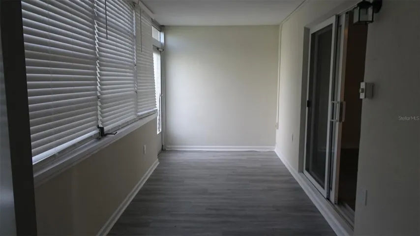 Florida room with rear door, soon to be replaced with a new exterior door.