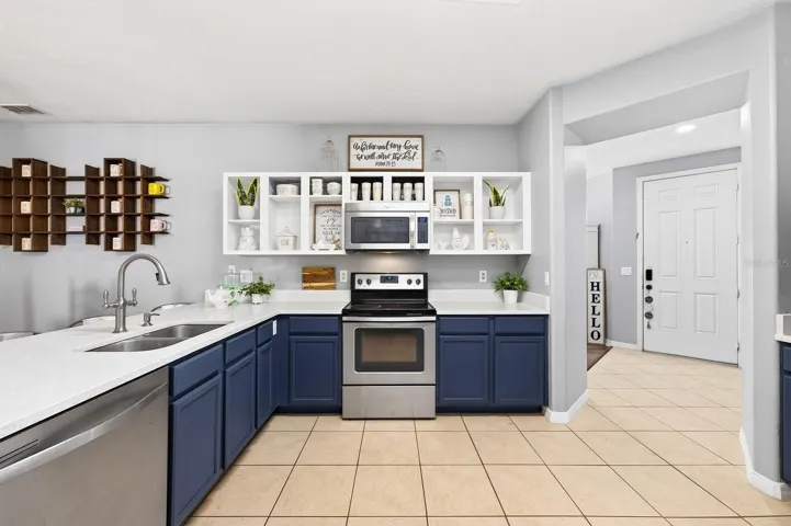 The heart of the home is the beautifully UPDATED KITCHEN featuring QUARTZ COUNTERTOPS, on trend cabinetry, STAINLESS STEEL APPLIANCES, a breakfast bar, pantry storage, and a sunny breakfast nook, all flowing seamlessly into the spacious family room.