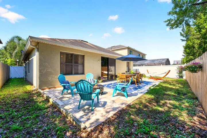 Open air patio and fenced backyard.