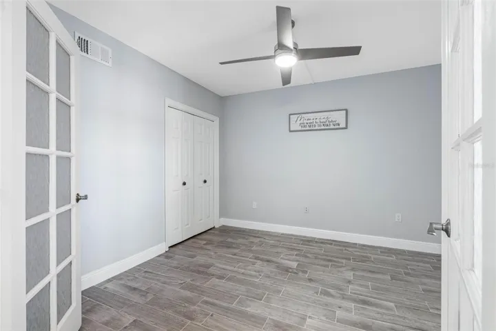 ... Main Floor Guest Bedroom #2 .. New Tile Floors - Closet and French Doors ..