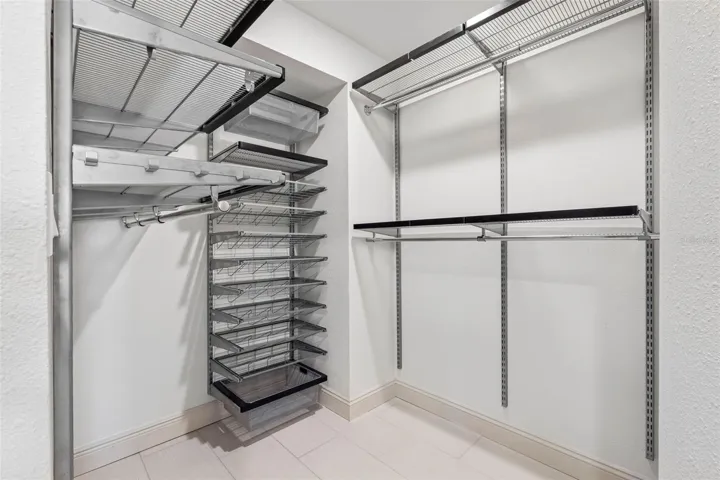 ..  Master  Bedroom Walk In Closet with designer built-ins including ELFA Master Closet System.