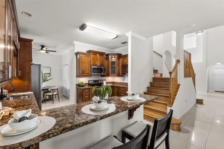 Bright and open gourmet kitchen featuring a functional breakfast bar for casual dining and morning coffee.