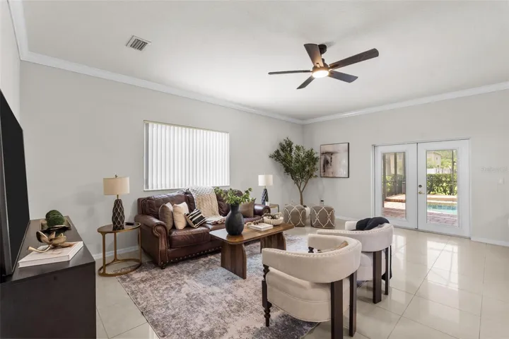 Family Room with french doors that exit to the spacious covered patio and private backyard oasis.