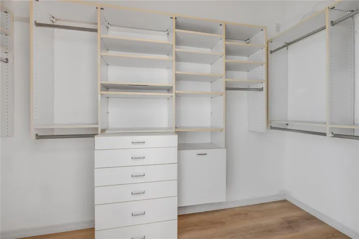 Primary bedroom walk in closet