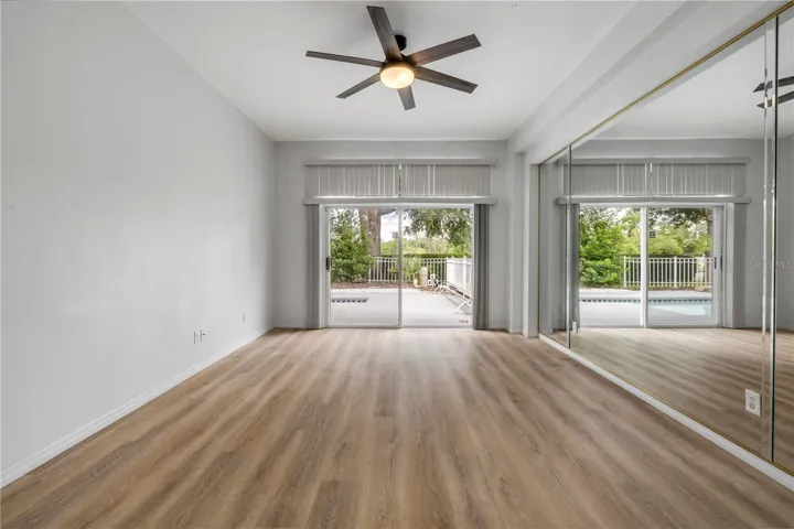 Primary bedroom with slider to pool