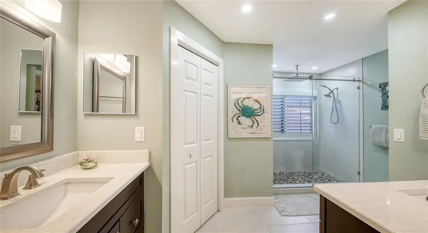 Brand new primary bathroom with 2 sinks, large walk-in shower and a walk-in closet.