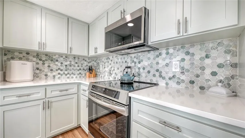 Quartz countertops, wood cabinets and brand new appliances.