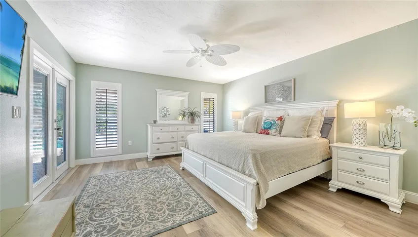 Huge main floor primary bedroom with double doors to the covered lanai.