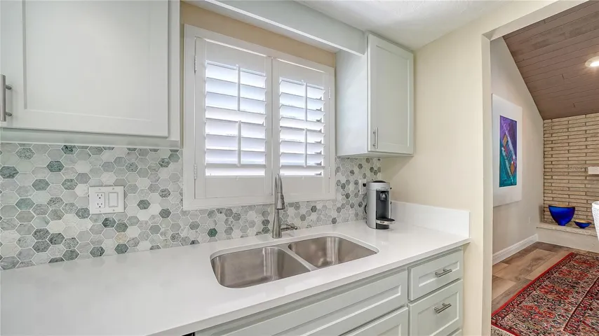 Double sinks and beautiful tile backsplash.