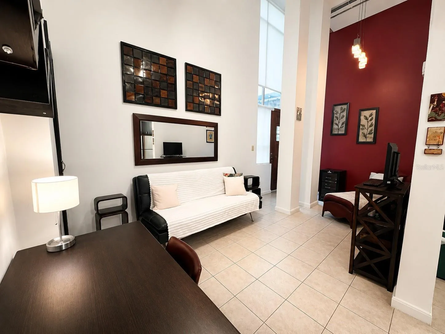 Living area featuring double-height ceilings, abundant natural light and open floor plan.