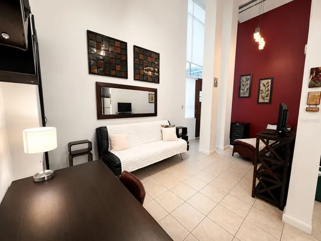 Living area featuring double-height ceilings, abundant natural light and open floor plan.