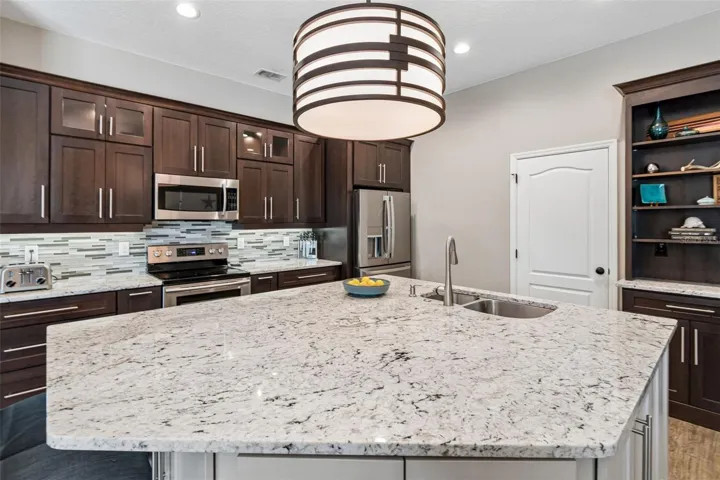 The built in drop zone cabinet to the right of the island is the perfect spot to charge your devices and display or store your cookbooks.