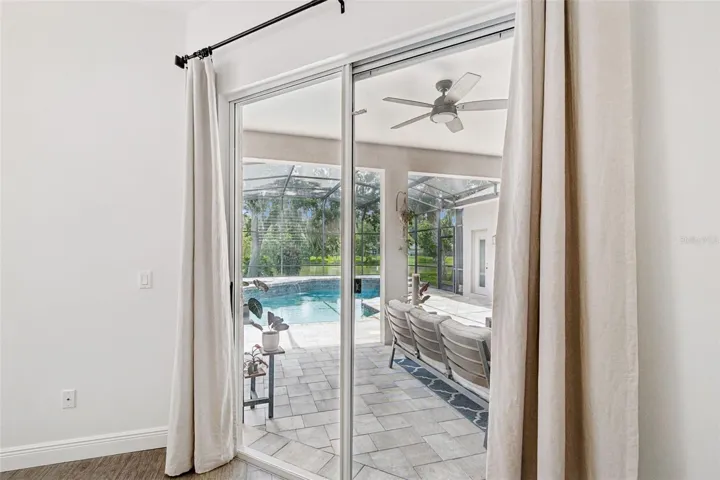 View and access to the pool and lanai from the primary bedroom