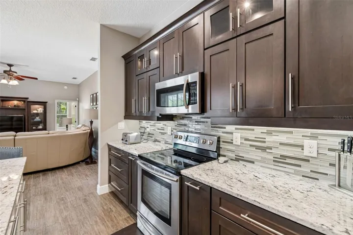 Roll out spice racks flank the stainless steel range on each side.