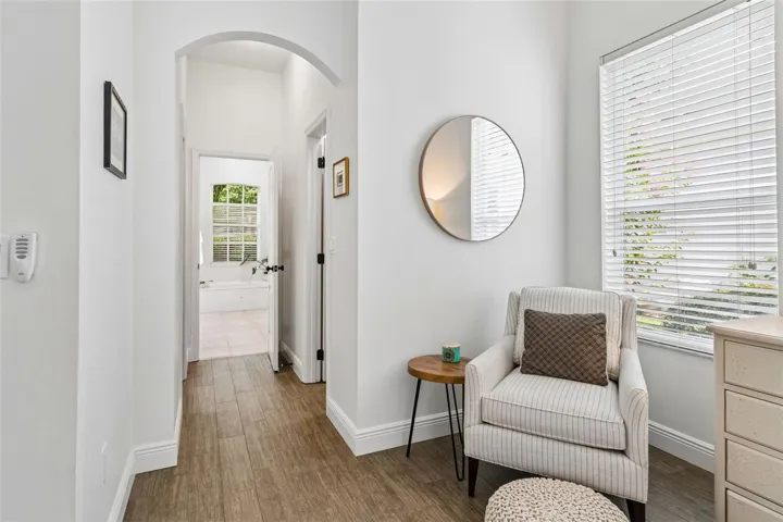 Hallway from primary to dual walk-in closets and primary bathroom