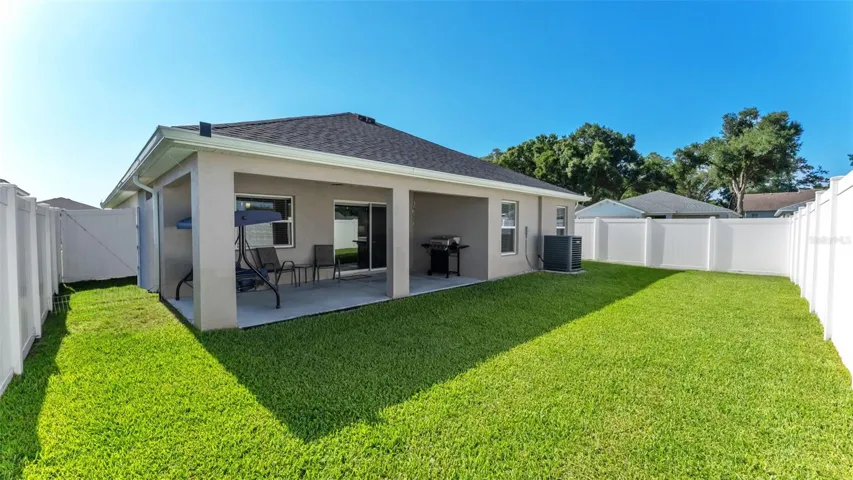 Back yard with vinyl fence