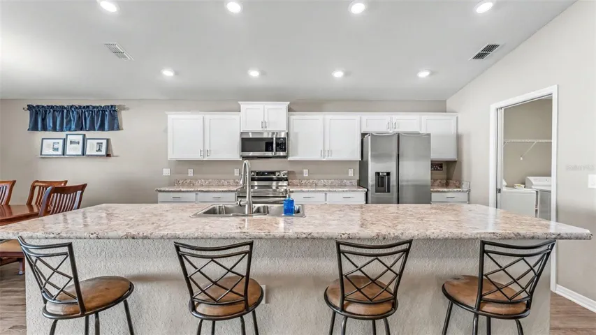Kitchen with large granite island with sink