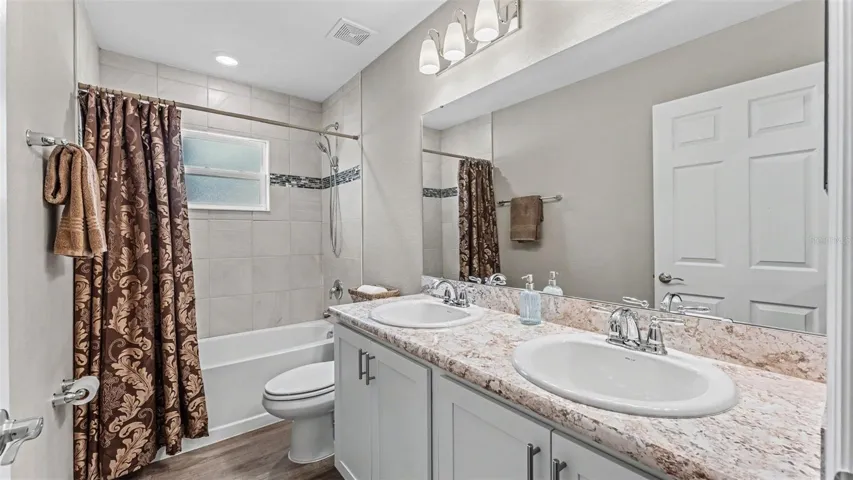 2nd bathroom with tub and double sinks