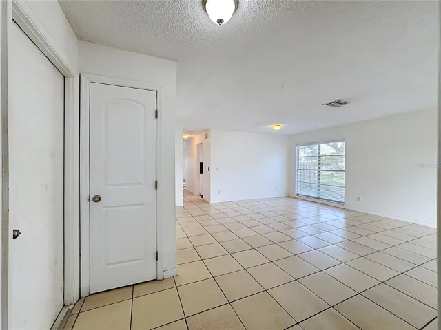 foyer, AC closet, garage door, looking into great room
