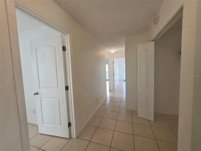 bedroom hallway from second bathroom, front bedroom to the left, laundry closet to the right