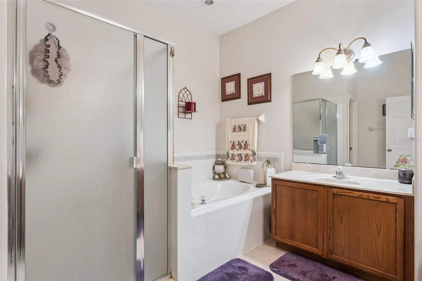 Primary bathroom features a walk in shower & spa like tub