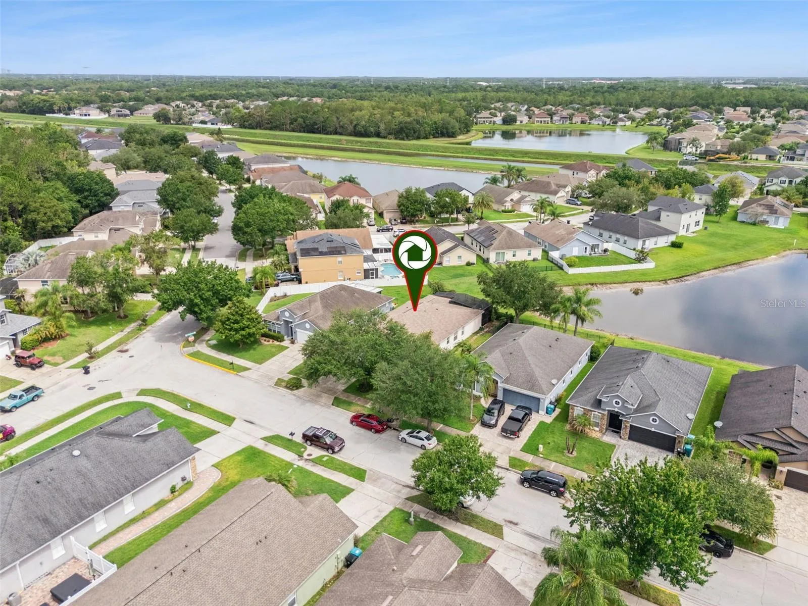 Aerial view of the home and surrounding community