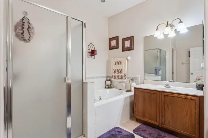 Primary bathroom features a walk in shower & spa like tub