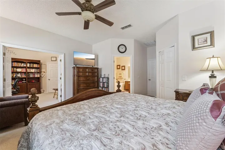 Primary Bedroom features double doors that open to the fourth bedroom which is currently used as a home oiffice