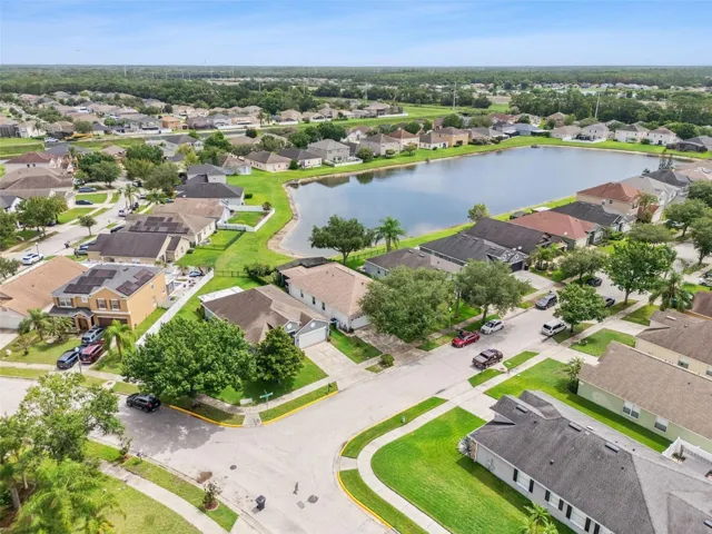 Aerial view of the home and community lake