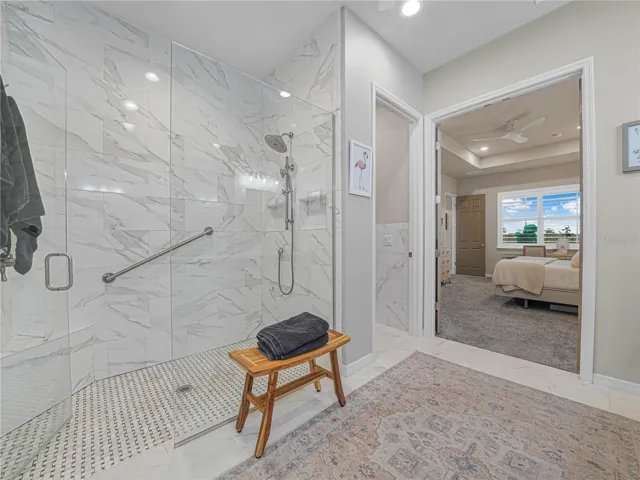 Calacatta Gold Glossy  Tile in the Shower with Grab Bars