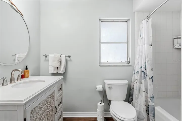 En-suite bathroom with newer vanity and shower/tub combo.