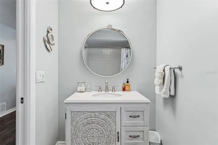 En-suite bathroom with newer vanity and shower/tub combo.