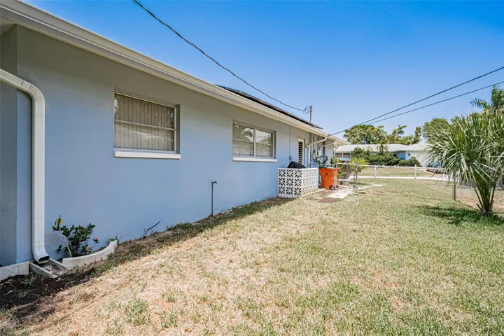 East side of house with door to the 2 car garage