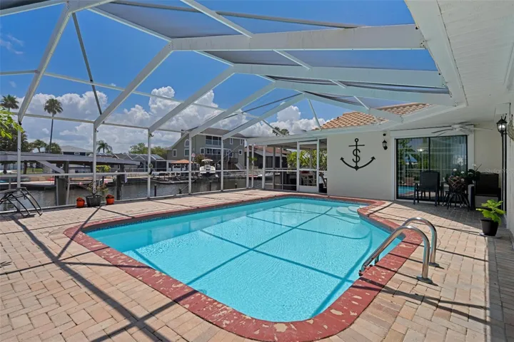 Screened Pool with Extended Brick Paver Patio Overlooking Canal