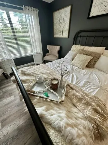 Primary suite with sitting are overlooks the pond and preserve