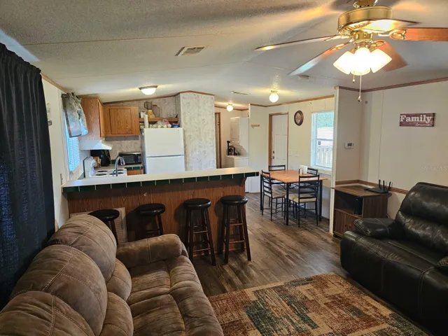Living room looking into the kitchen and dining area and laundry area