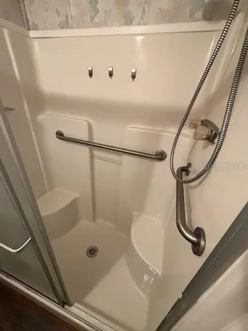step in shower with built in seating and handicap bars
