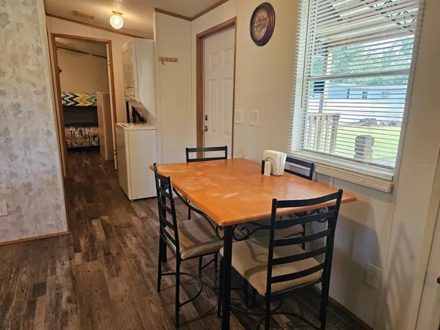 Dining area with window, laundry area, bathroom and back bedroom