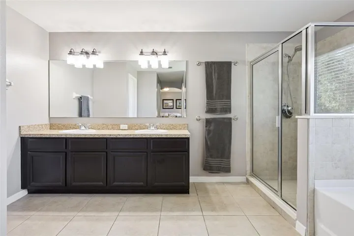 The primary bath features dual sinks, a garden tub, separate shower, and the function move-up buyers expect.