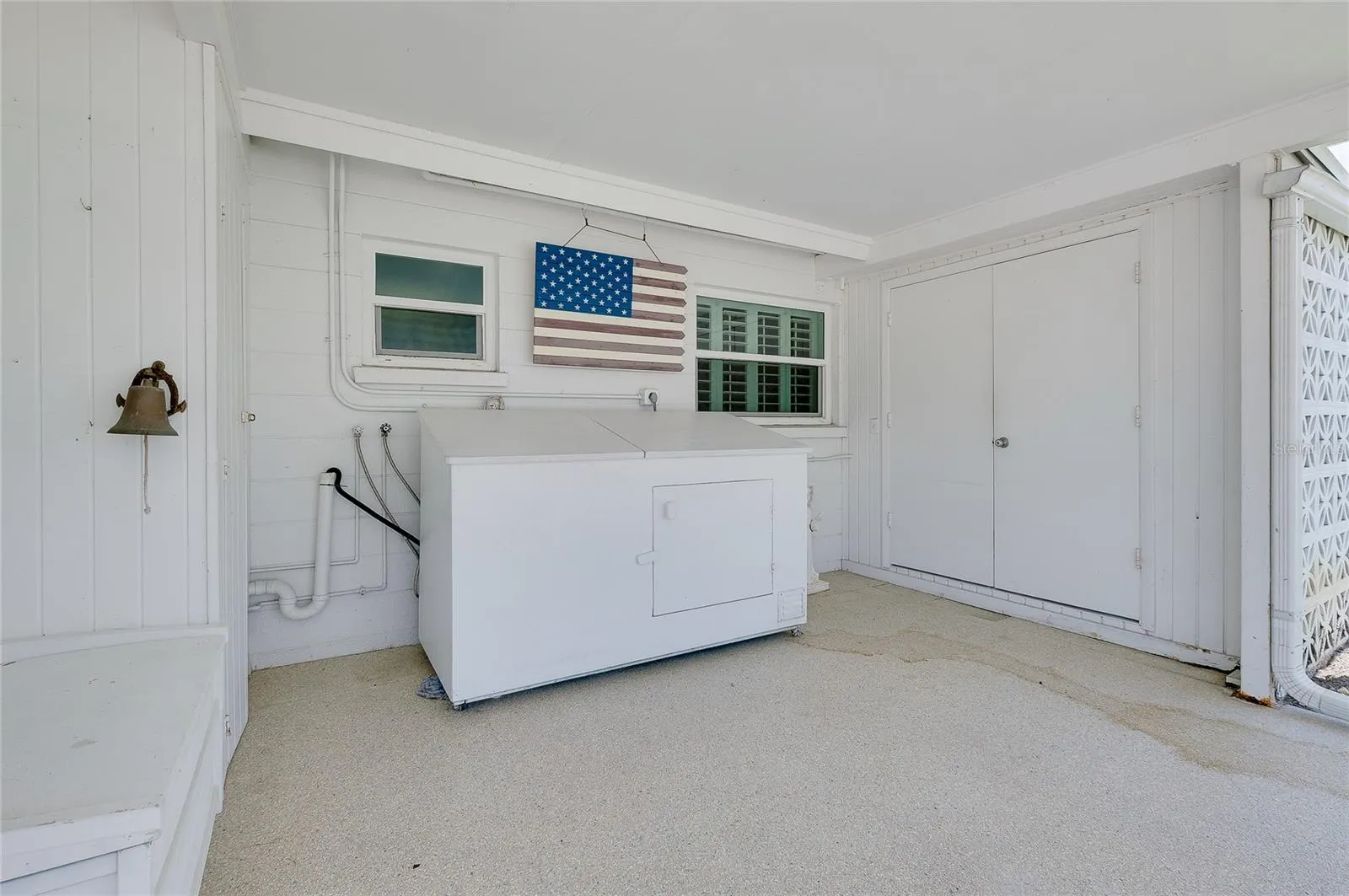 The laundry cabinetry is on wheels and can also be pulled out.