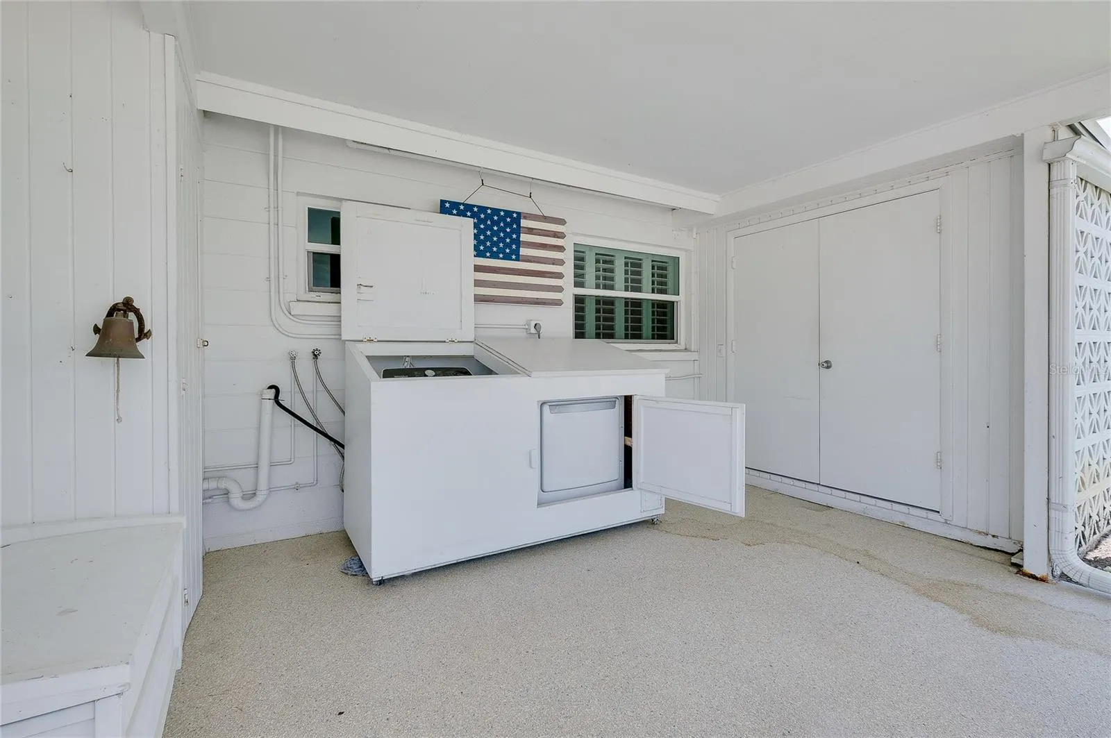 Washer & dryer enclosed in novel cabinetry.
