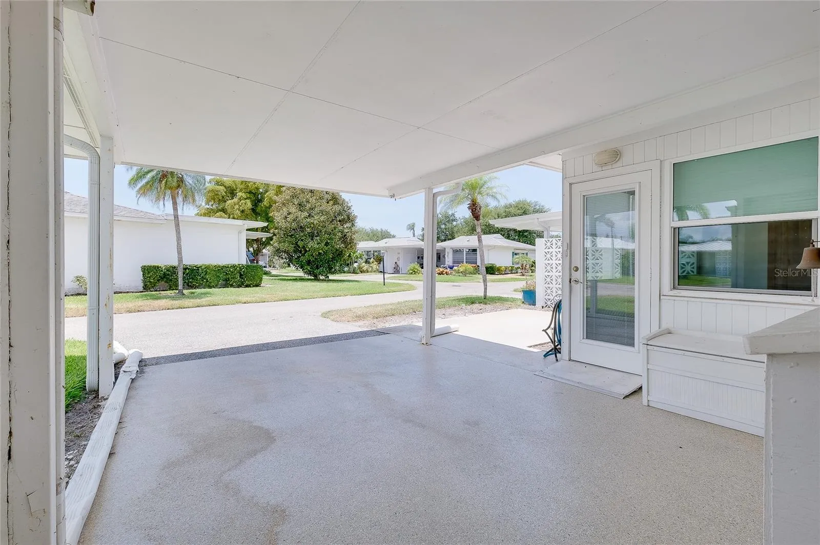 Carport with door to Florida room and showing proximity to patio.