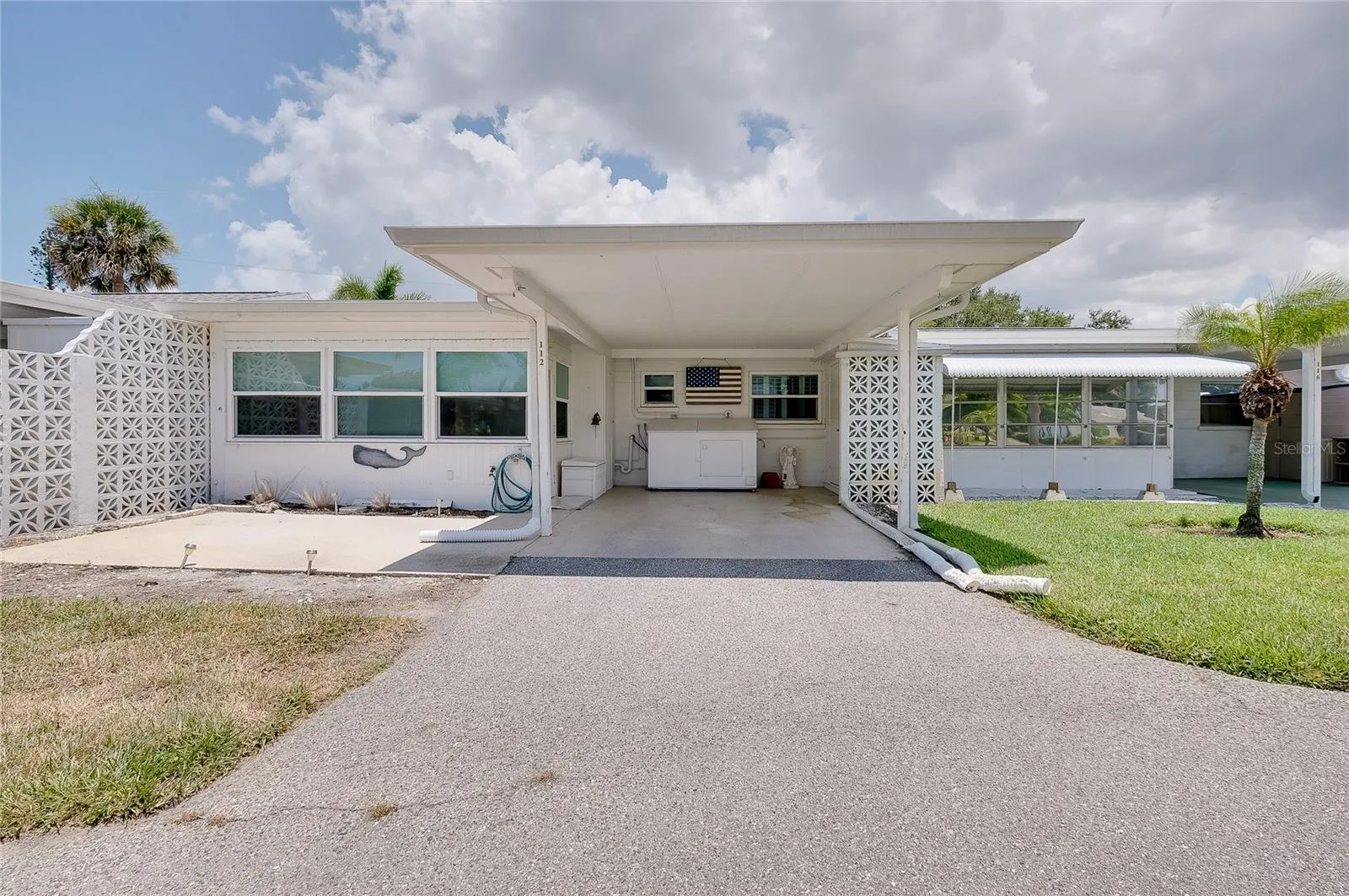 Carport and patio are to the rear of the villa.