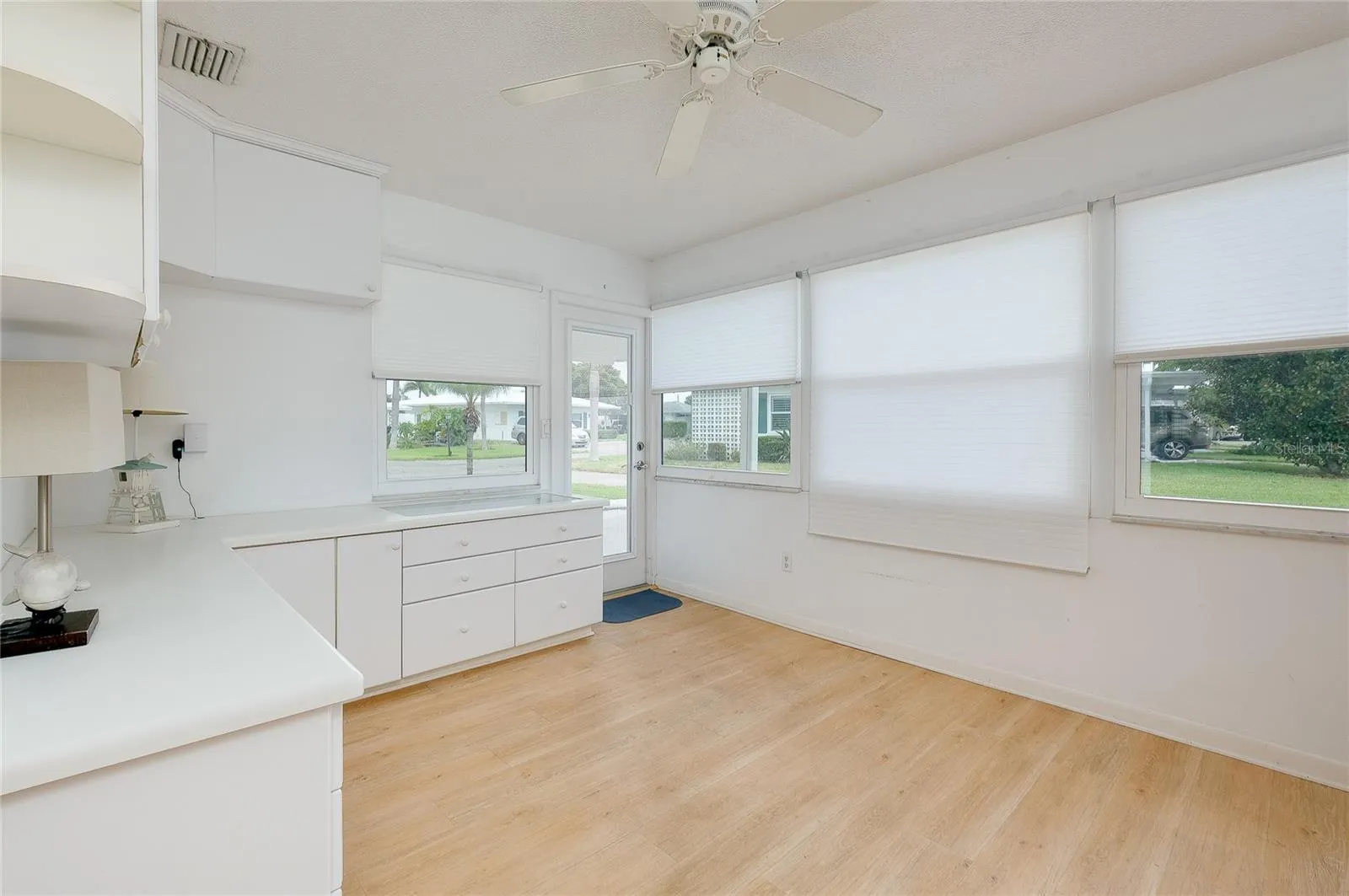 Florida room with door to carport and patio area