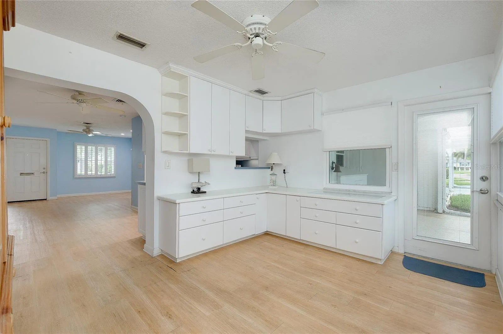 Enclosed Florida room with built-in cabinetry and pass through from kitchen