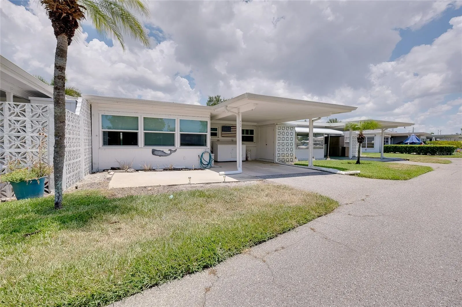 Carport and patio are to the rear of the villa.