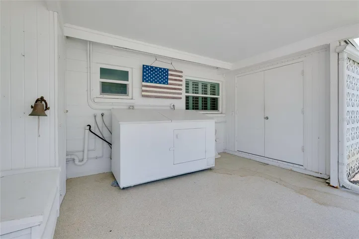 The laundry cabinetry is on wheels and can also be pulled out.