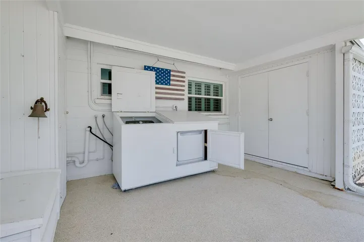 Washer &amp; dryer enclosed in novel cabinetry.