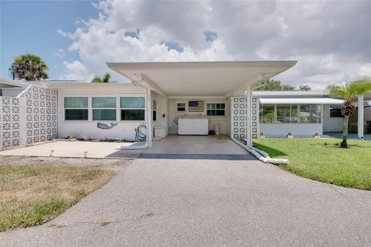 Carport and patio are to the rear of the villa.