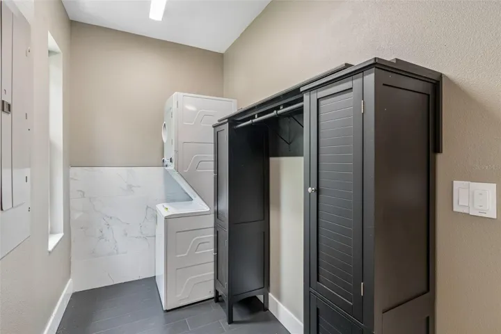 Stackable washer &amp; dryer located next to the kitchen